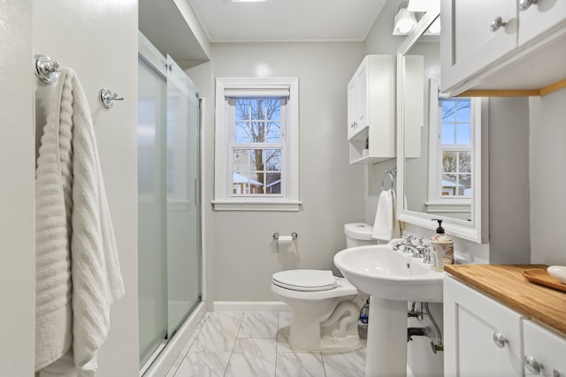 bathroom with a wealth of natural light, an enclosed shower, and toilet