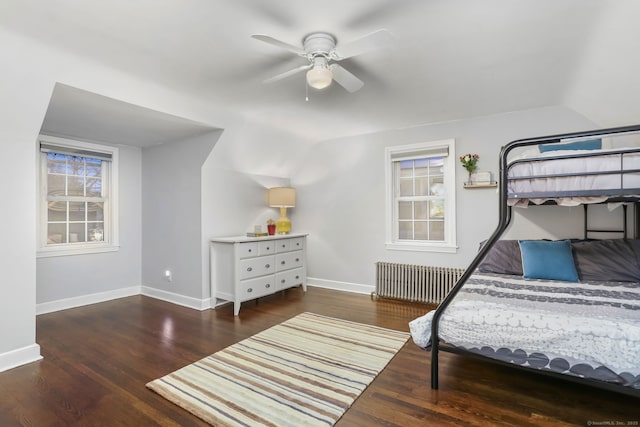 bedroom with ceiling fan, lofted ceiling, dark wood-type flooring, and radiator