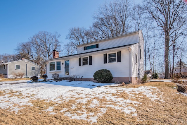 view of front of house featuring a chimney