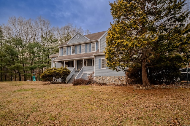 view of front of home featuring a front lawn and covered porch