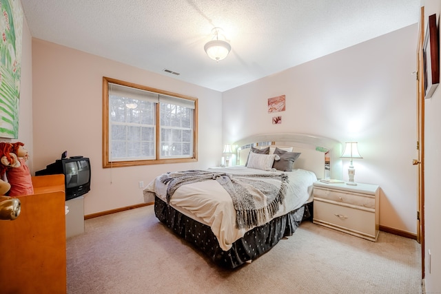 carpeted bedroom with a textured ceiling