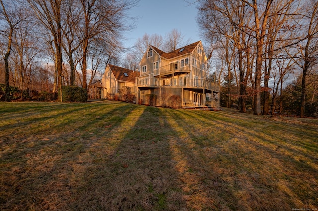 back of house with a deck and a yard