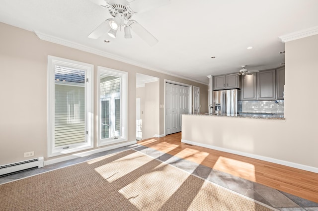 unfurnished living room with ceiling fan, a baseboard heating unit, light hardwood / wood-style flooring, and ornamental molding