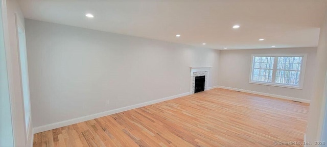 unfurnished living room featuring light wood-type flooring