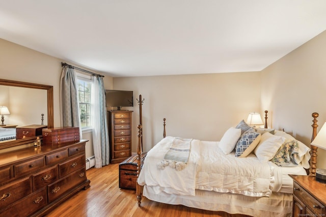 bedroom featuring a baseboard radiator and light wood-type flooring