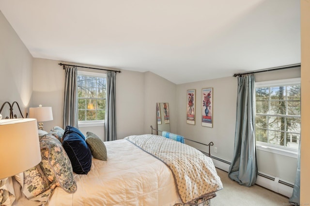 bedroom with light colored carpet and a baseboard heating unit