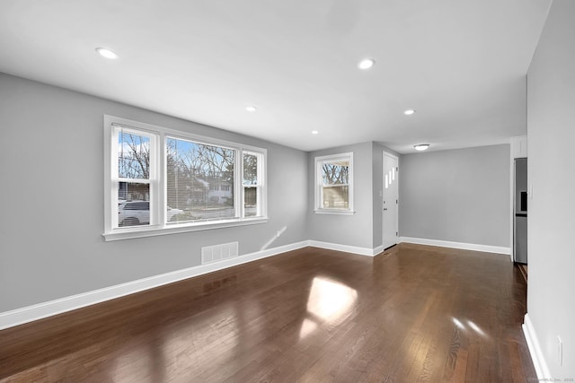 unfurnished room with dark hardwood / wood-style floors