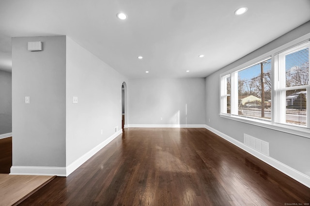 unfurnished room featuring dark wood-type flooring