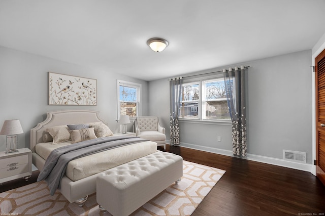 bedroom with dark wood-type flooring