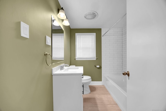 full bathroom featuring hardwood / wood-style floors, vanity, toilet, and tiled shower / bath