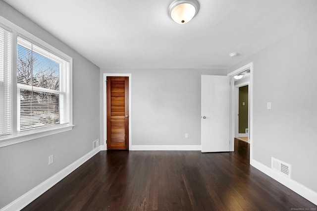 spare room with dark hardwood / wood-style floors