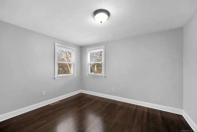 unfurnished room with hardwood / wood-style flooring