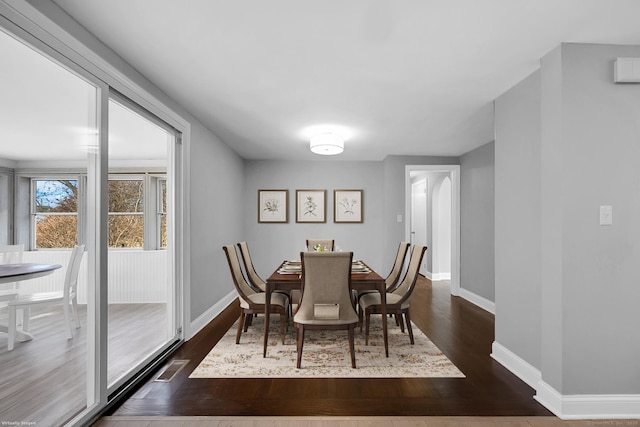 dining area featuring dark wood-type flooring