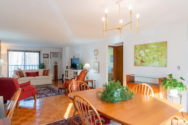 dining room with a notable chandelier, parquet flooring, a baseboard radiator, and an AC wall unit