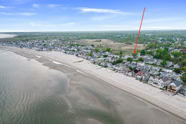 drone / aerial view with a water view and a view of the beach