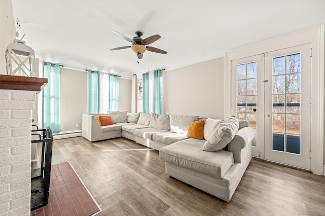 living room with wood-type flooring, a wealth of natural light, and ceiling fan