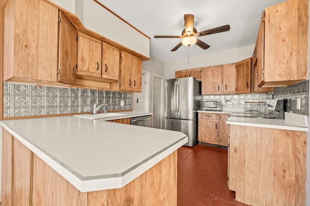 kitchen featuring kitchen peninsula, backsplash, stainless steel appliances, and sink