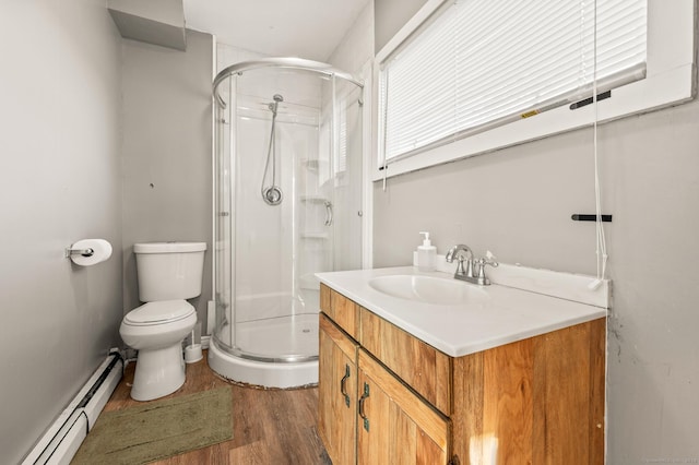 bathroom featuring vanity, a shower with door, a baseboard radiator, hardwood / wood-style floors, and toilet