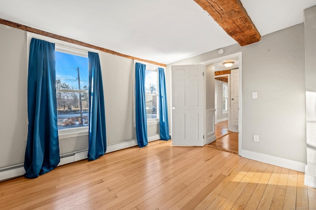 spare room featuring a baseboard radiator and light wood-type flooring