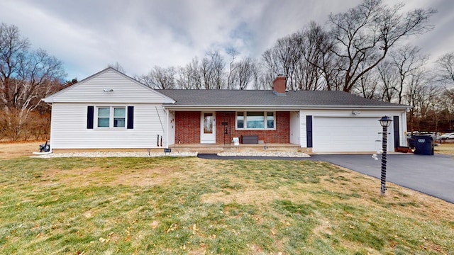 ranch-style home with covered porch, a front lawn, and a garage