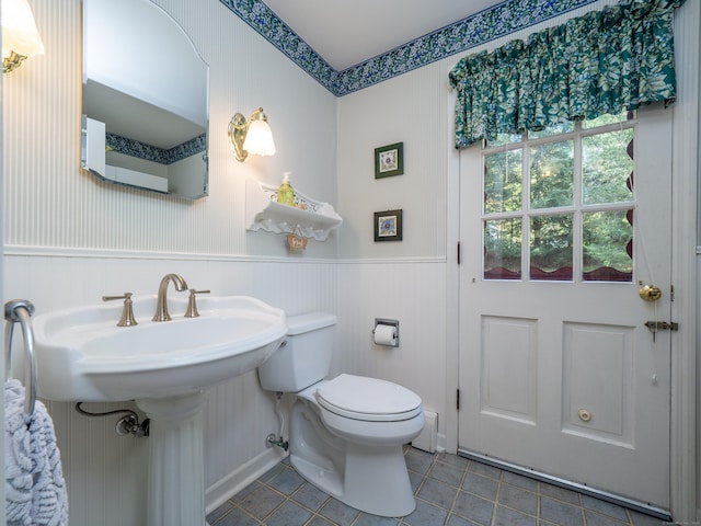 bathroom featuring sink, toilet, and tile patterned flooring