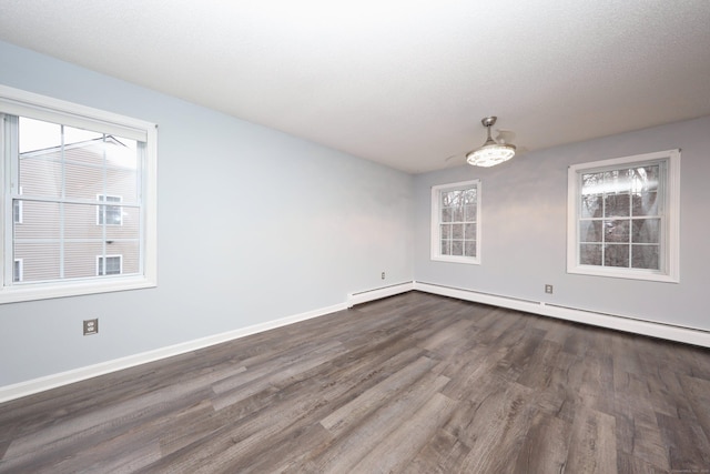 unfurnished dining area featuring dark hardwood / wood-style flooring and a baseboard radiator