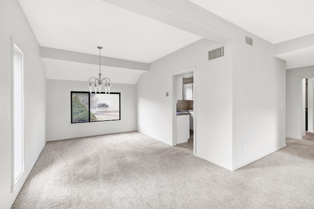 unfurnished room with light colored carpet, lofted ceiling, and an inviting chandelier