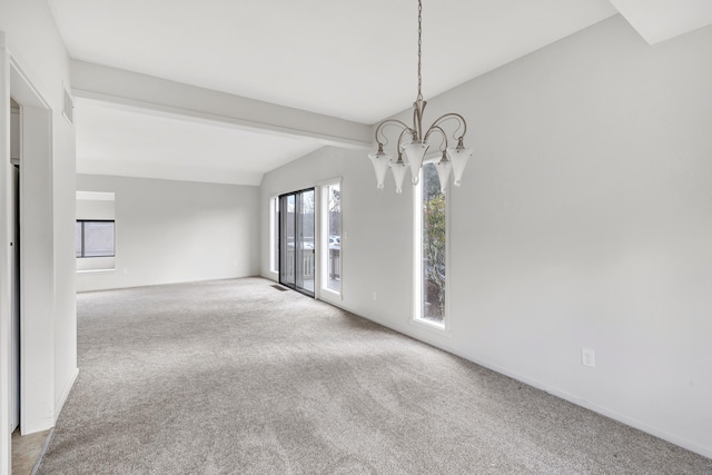 carpeted spare room featuring vaulted ceiling and a notable chandelier