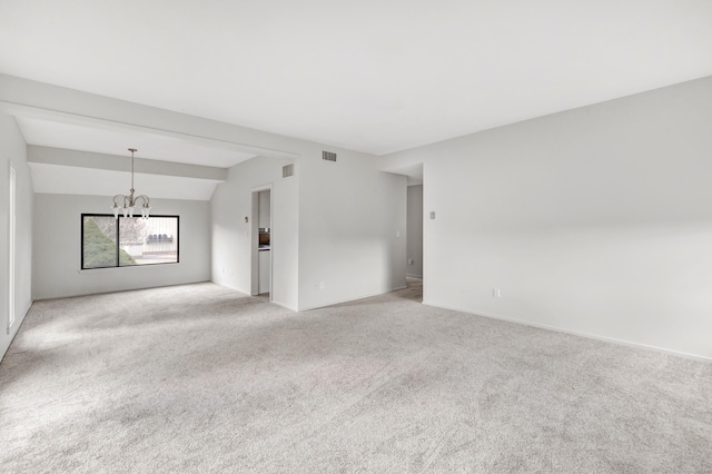 unfurnished room featuring vaulted ceiling, light colored carpet, and a chandelier