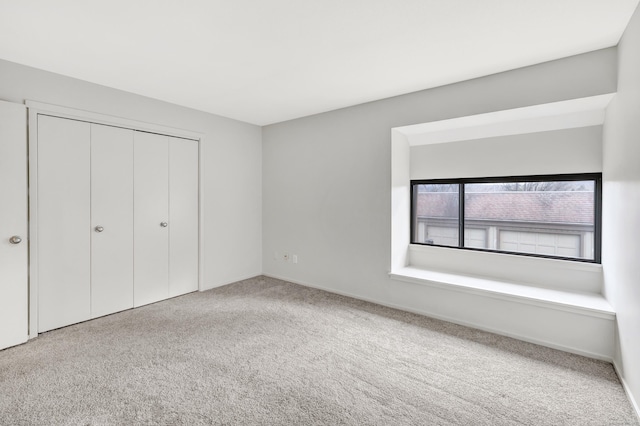 unfurnished bedroom with carpet flooring and a closet