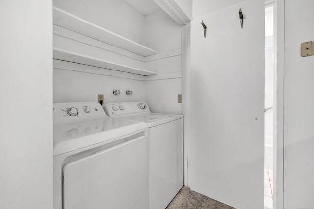 washroom with carpet floors and washer and clothes dryer