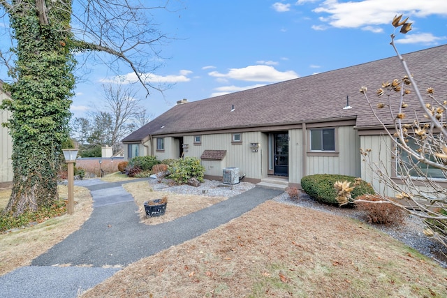 rear view of property featuring central AC unit