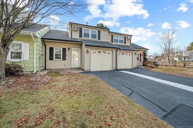 front of property with a front lawn and a garage