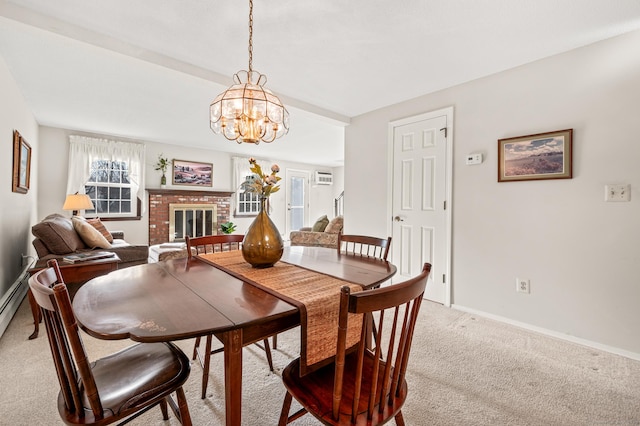 carpeted dining space with a fireplace and a chandelier