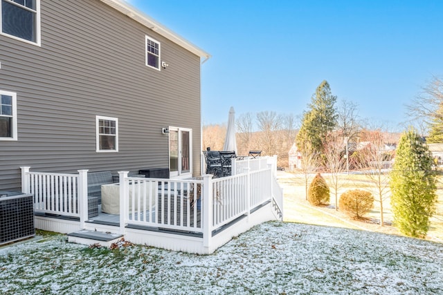 back of property with central AC unit and a deck