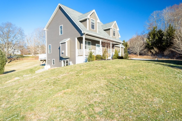 view of front facade featuring covered porch and a front yard