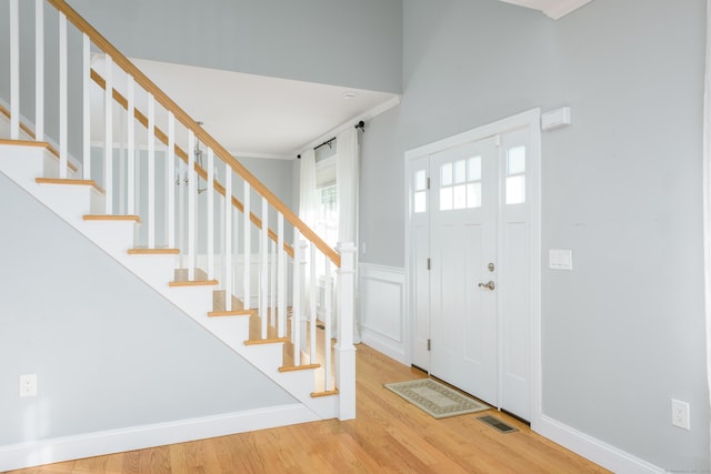 entryway featuring crown molding and hardwood / wood-style floors