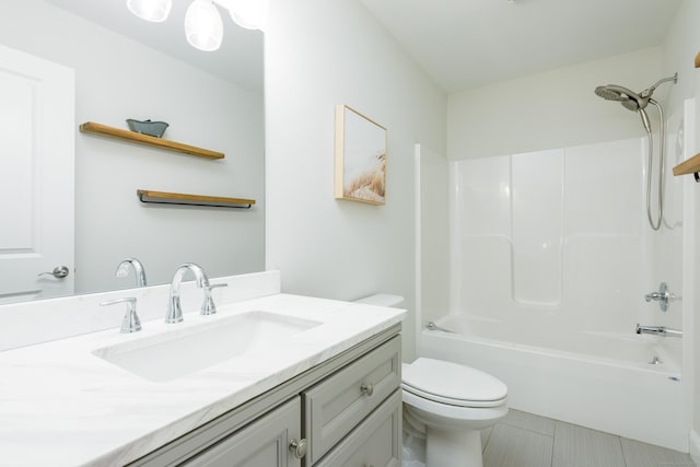 full bathroom featuring tile patterned floors, shower / washtub combination, vanity, and toilet