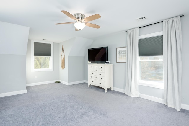 interior space featuring ceiling fan, lofted ceiling, and light carpet