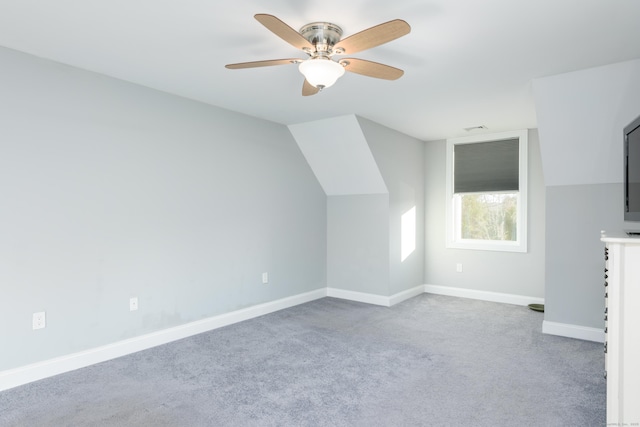 additional living space with carpet flooring, ceiling fan, and vaulted ceiling