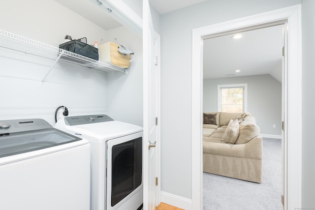 washroom featuring light colored carpet and washing machine and clothes dryer