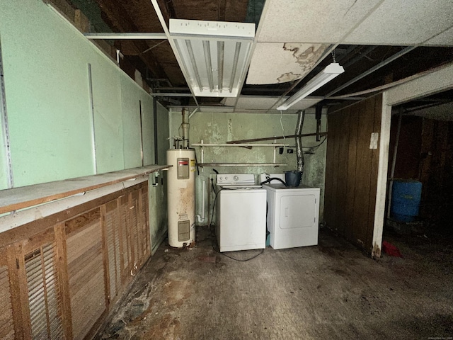 basement with water heater and independent washer and dryer