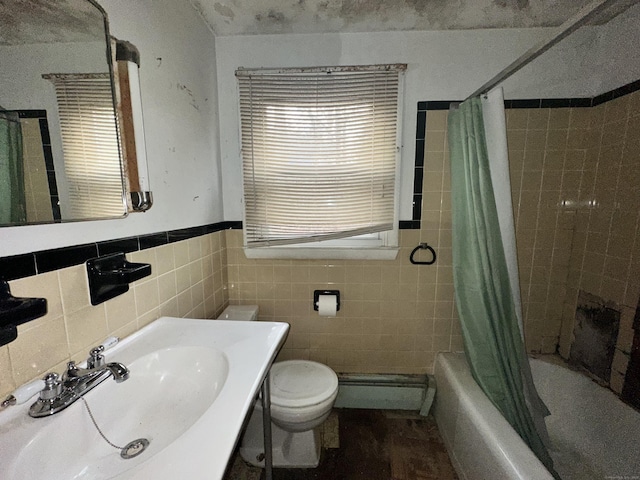 full bathroom featuring shower / bathtub combination with curtain, baseboard heating, toilet, tile walls, and sink