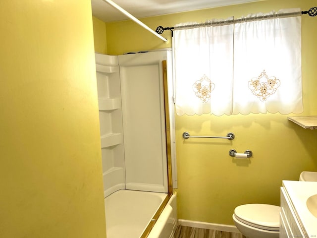 full bathroom featuring bathing tub / shower combination, hardwood / wood-style floors, vanity, and toilet