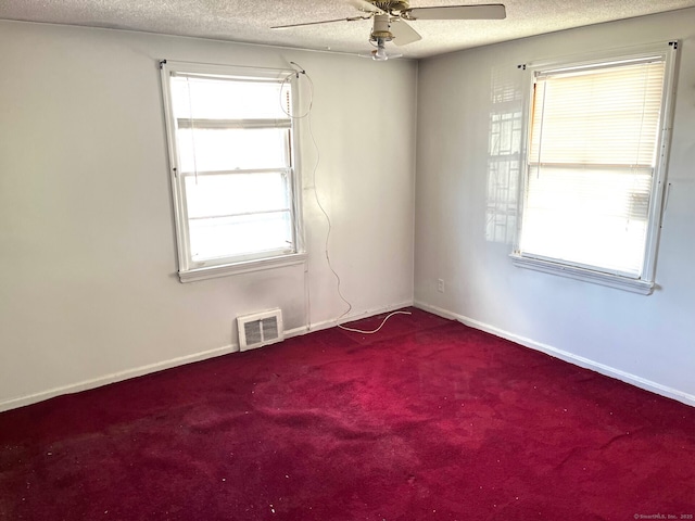 spare room with carpet, ceiling fan, and a textured ceiling