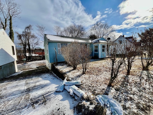 view of snow covered back of property