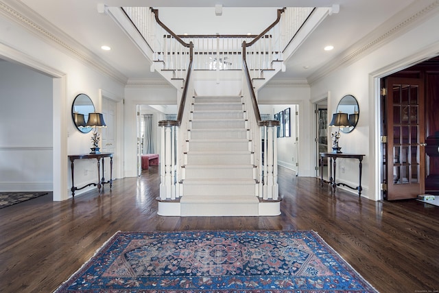 foyer with dark hardwood / wood-style flooring and crown molding