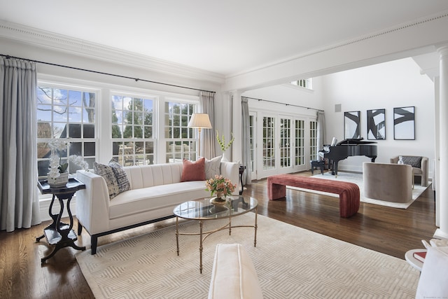 living room featuring crown molding, hardwood / wood-style flooring, and ornate columns