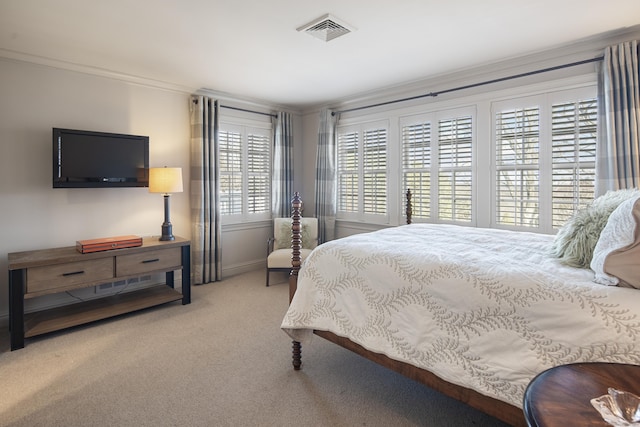 carpeted bedroom featuring crown molding