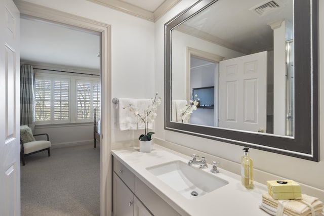 bathroom featuring crown molding and vanity